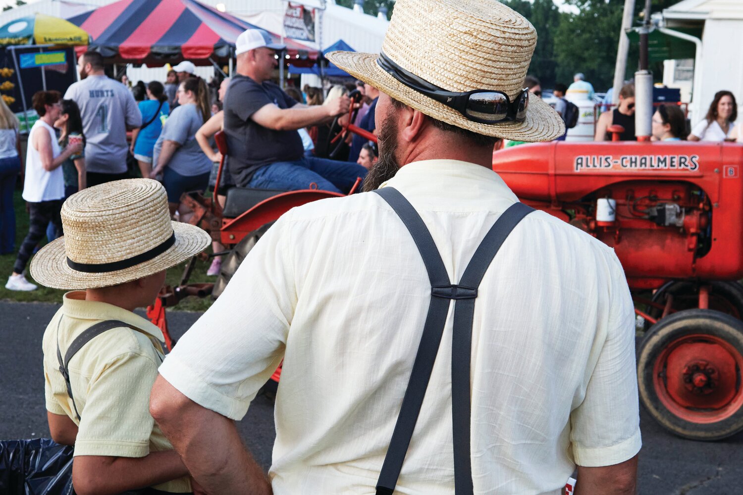 Visitors watch the tractor parade at the Middletown Grange Fair Aug. 17.