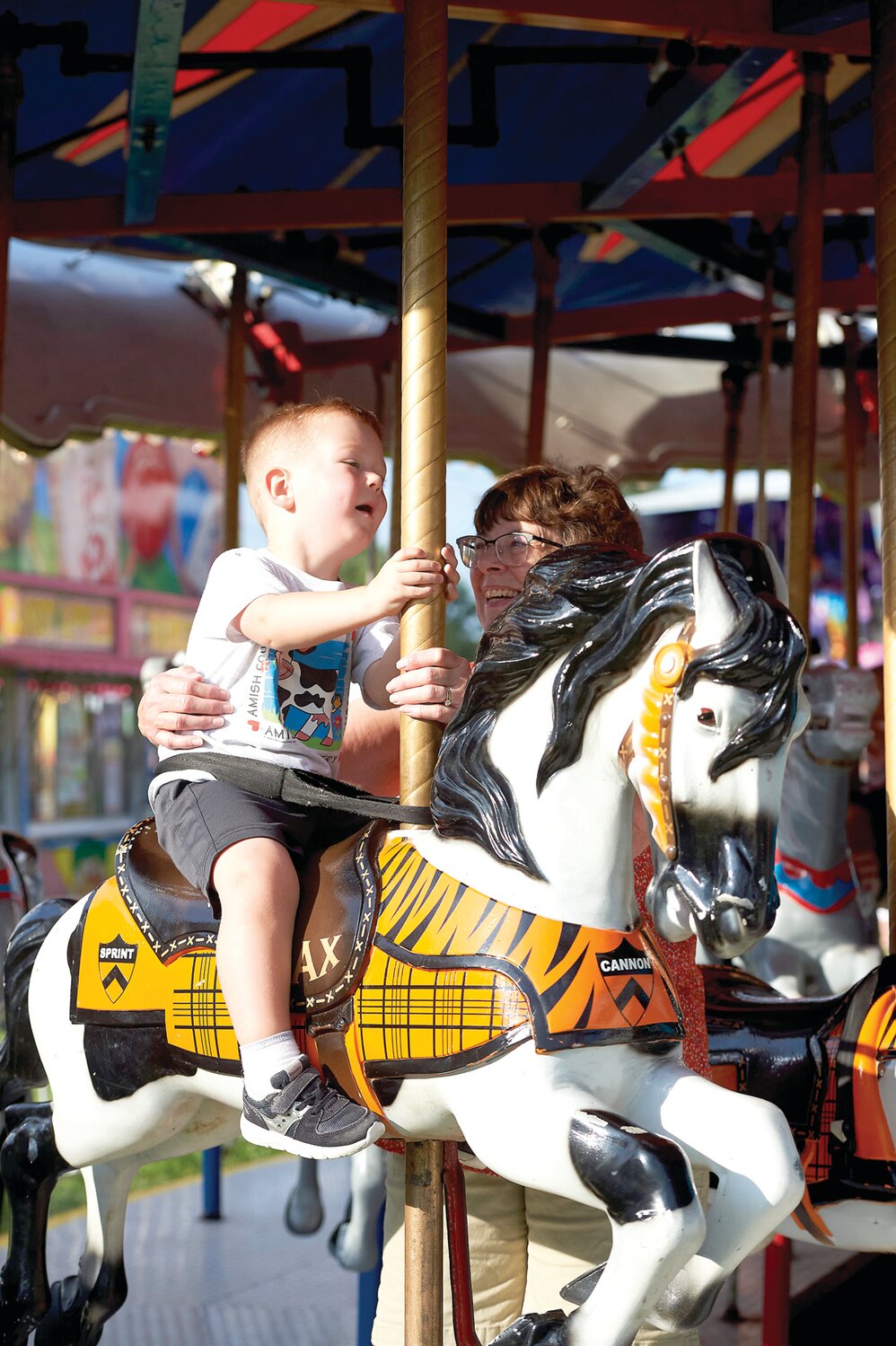 A youngster is all smiles as he rides the carousel at the Middletown Grange Fair Aug. 17.