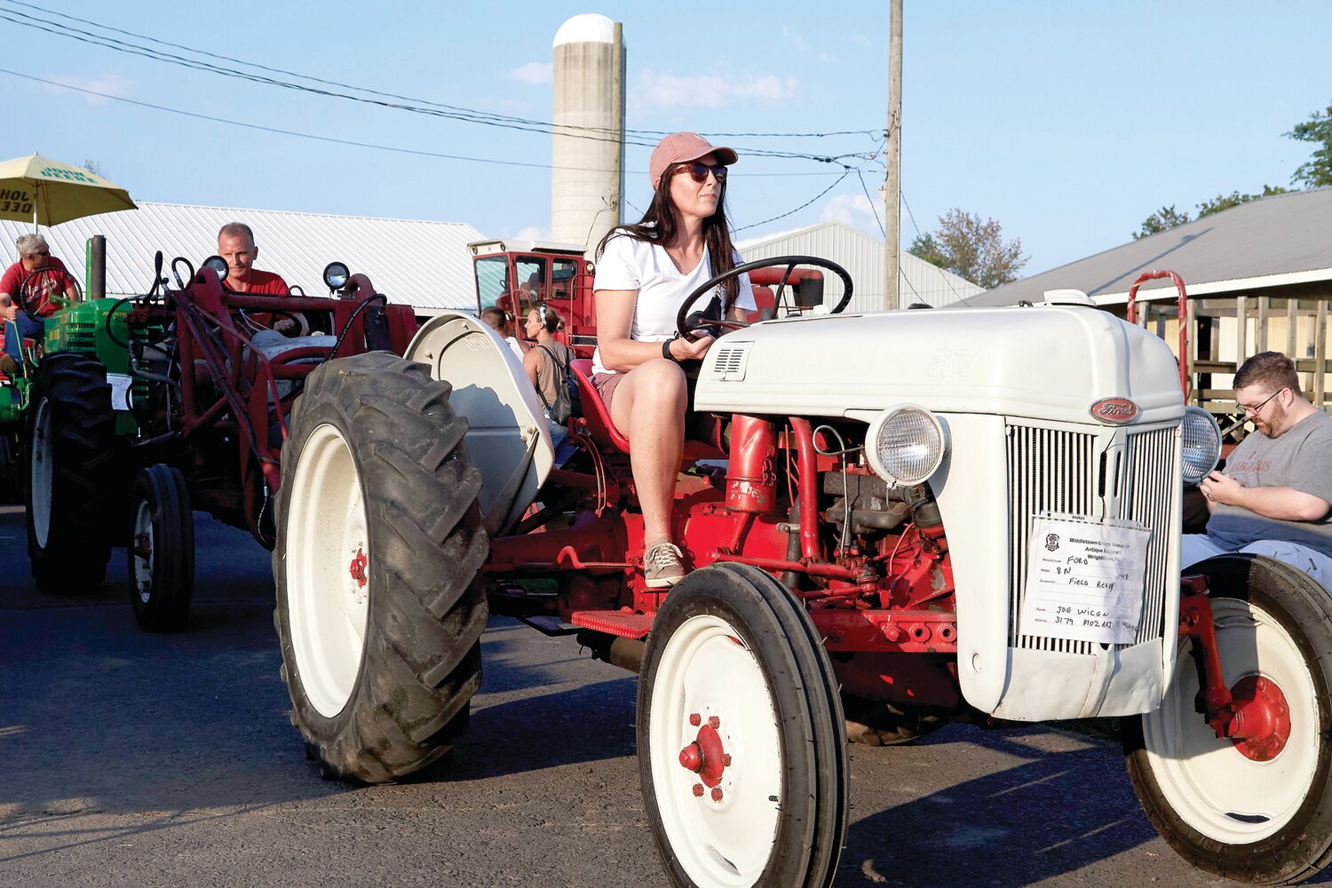 Kathleen Briarly drives Joe Wicen’s tractor in the tractor parade during the Middletown Grange Fair Aug. 17.