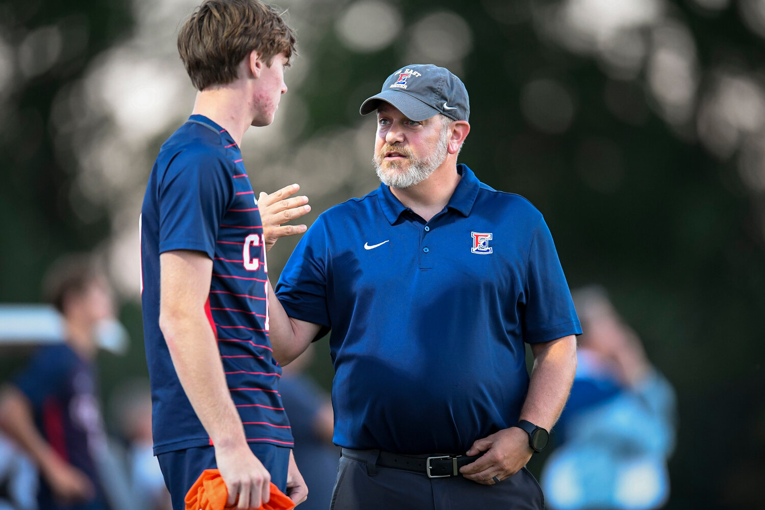 Central Bucks East coach Josh Isaacsohn gives last minute instructions to Nick Bonargo right before getting into the game during the first half.