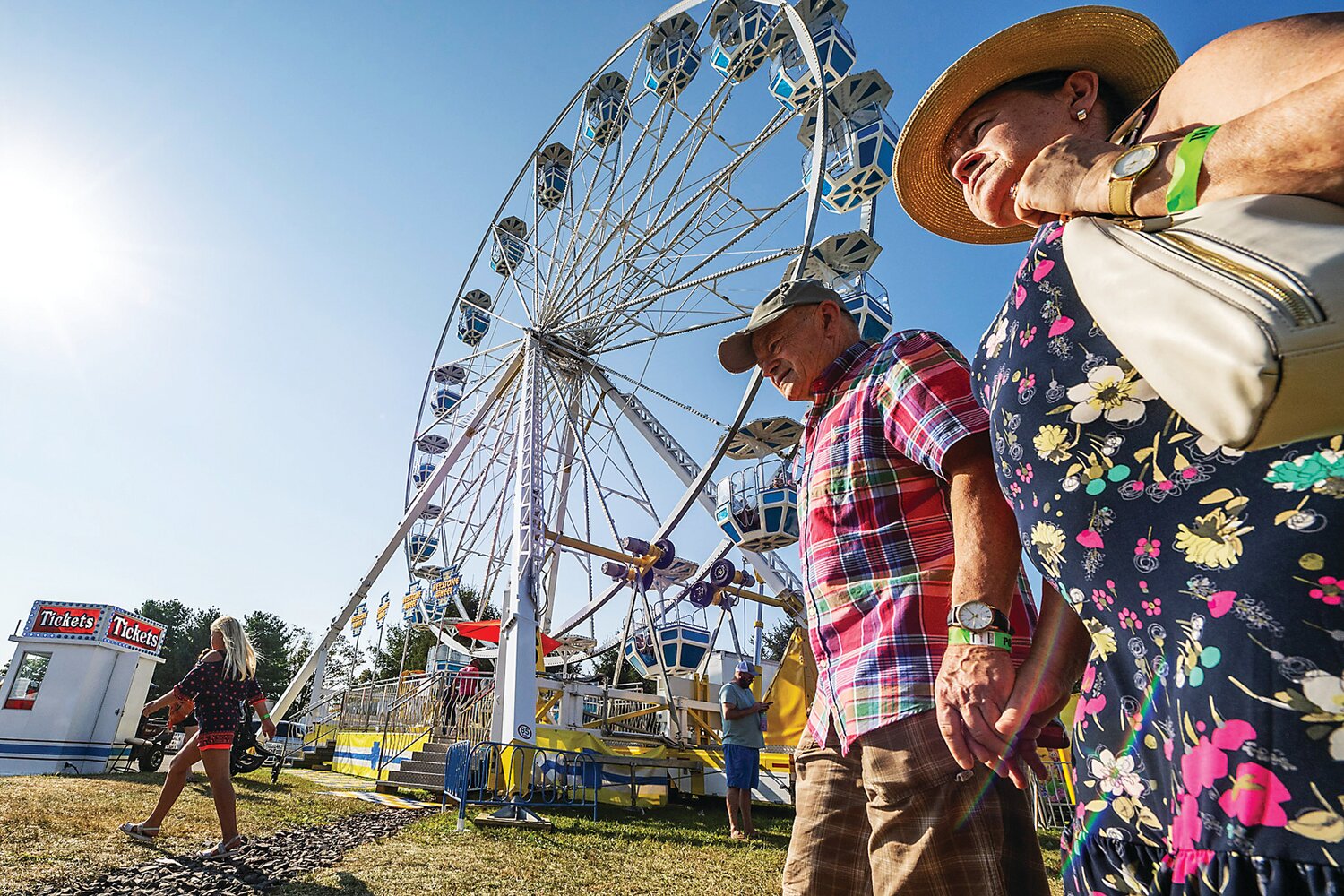 Festival goers walk hand-in-hand through the fair grounds.