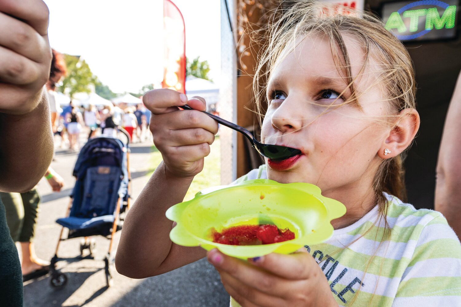 As temperatures soar above 90 degrees, Emma Klisiewicz enjoys some water ice during the 57th annual Polish American Family Festival & Country Fair 2023 Sunday at Our Lady of Czestochowa in New Britain Township.