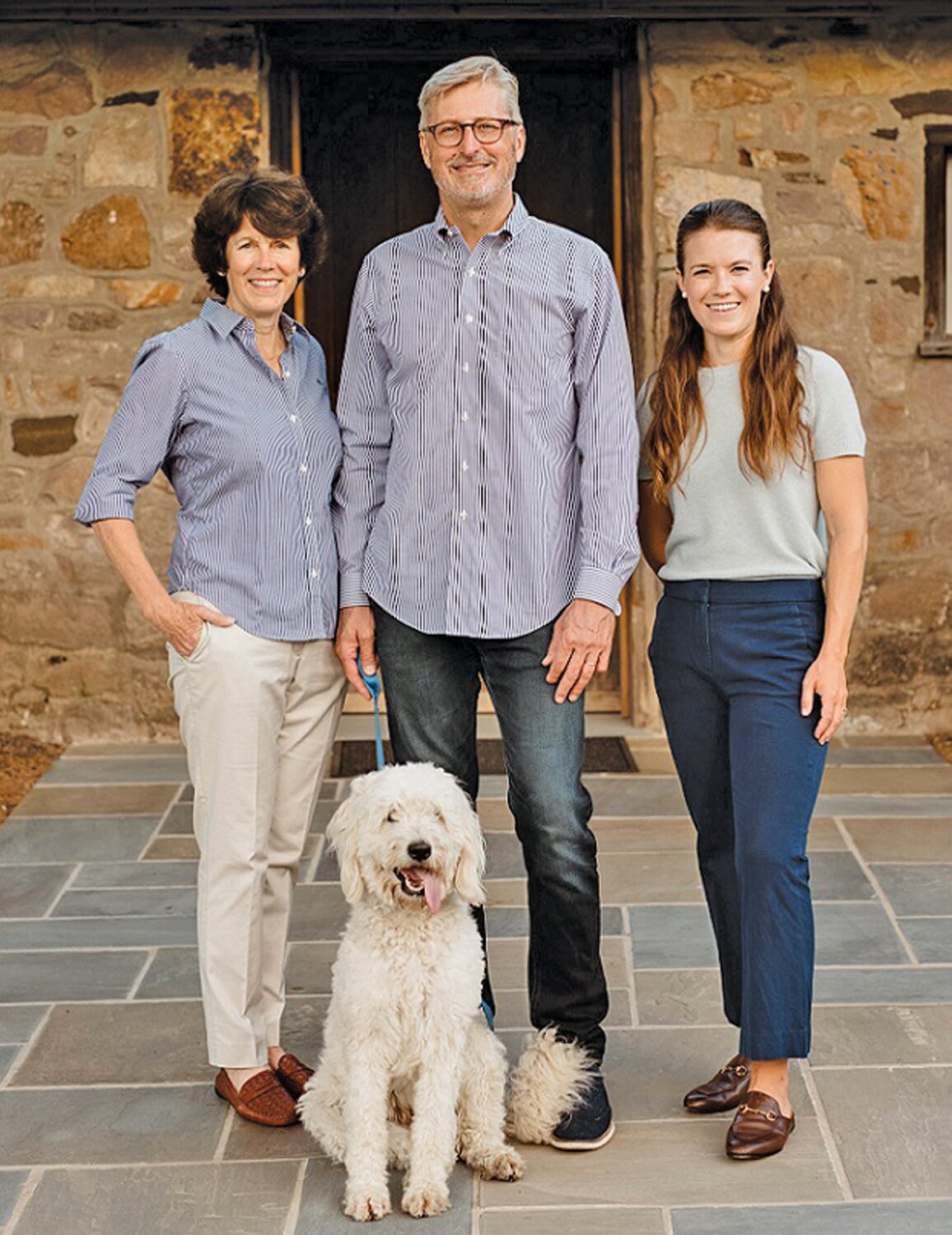 The Inn at Fox Briar Farm owners Donna Jamison Cave and Jeff Cave stand with innkeeper Kendall Rood at the Buckingham farm-turned-bed and breakfast. With them is Briar, the Caves’  2-year-old Goldendoodle.