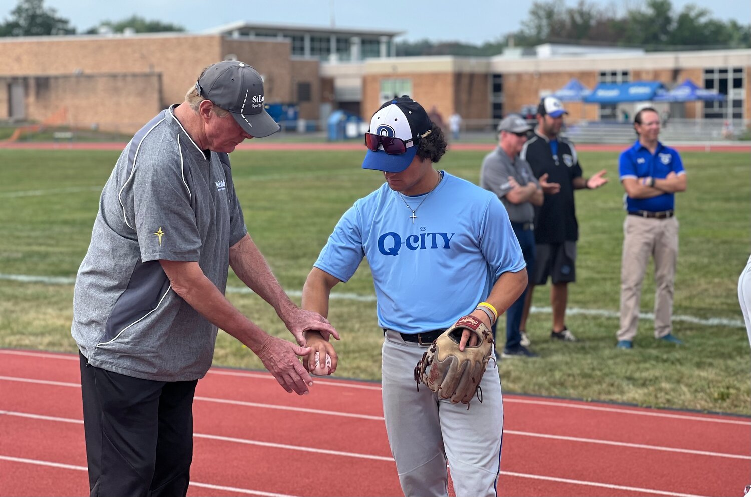 Steve Carlton works with Quakertown High School senior Danny Qualteria on his pitching technique at a baseball clinic sponsored by St. Luke’s on Sept. 9.