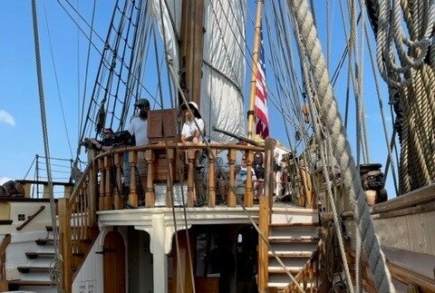 Capt. Lauren Morgens (in white shirt and hat) on the upper deck on the Kalmar Nyckel.