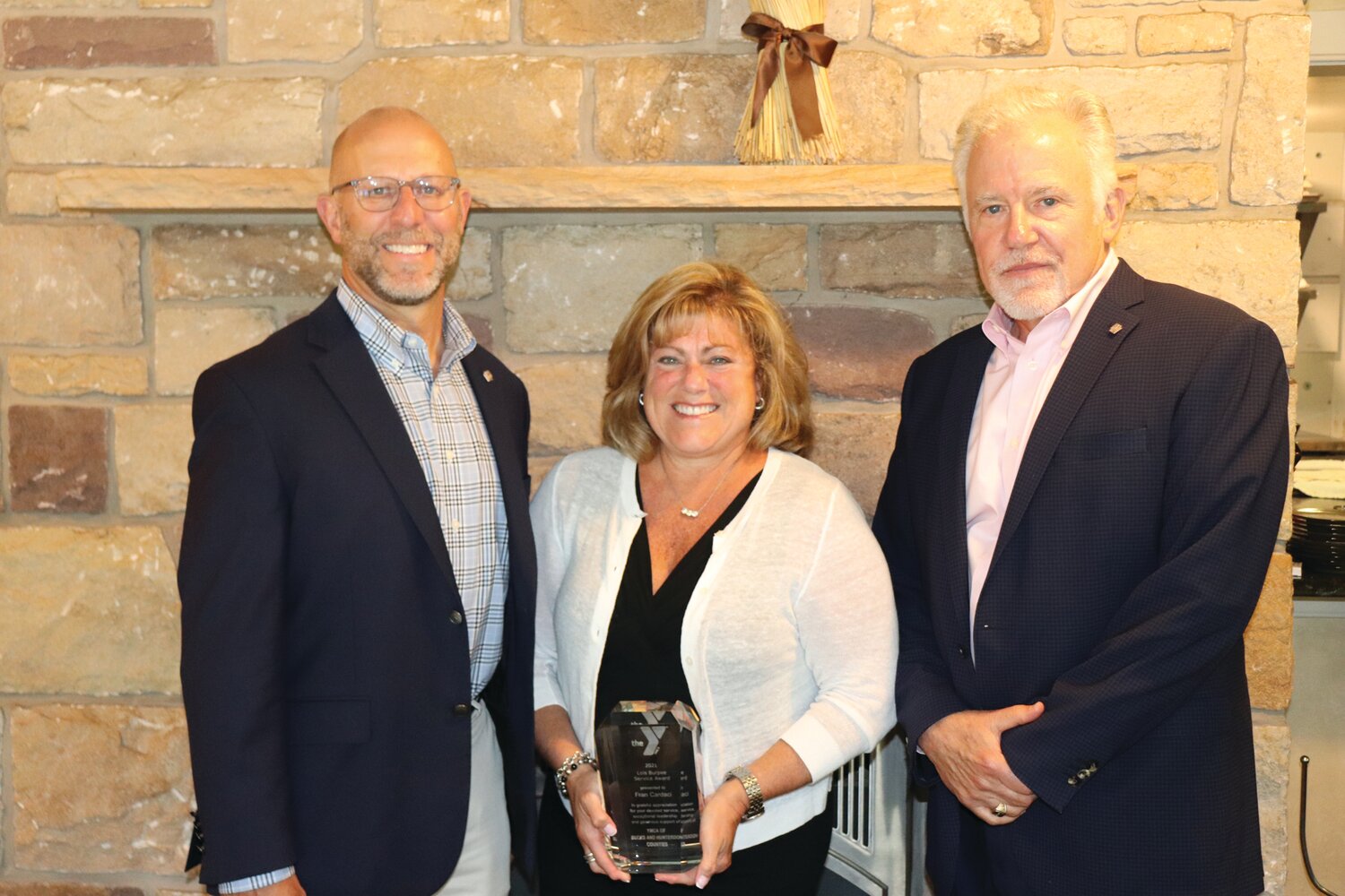 From left are: President/CEO of YMCA of Bucks and Hunterdon Counties Zane Moore with Burpee Award recipient Fran Cardaci and Chief Volunteer Officer Allen Childs.
