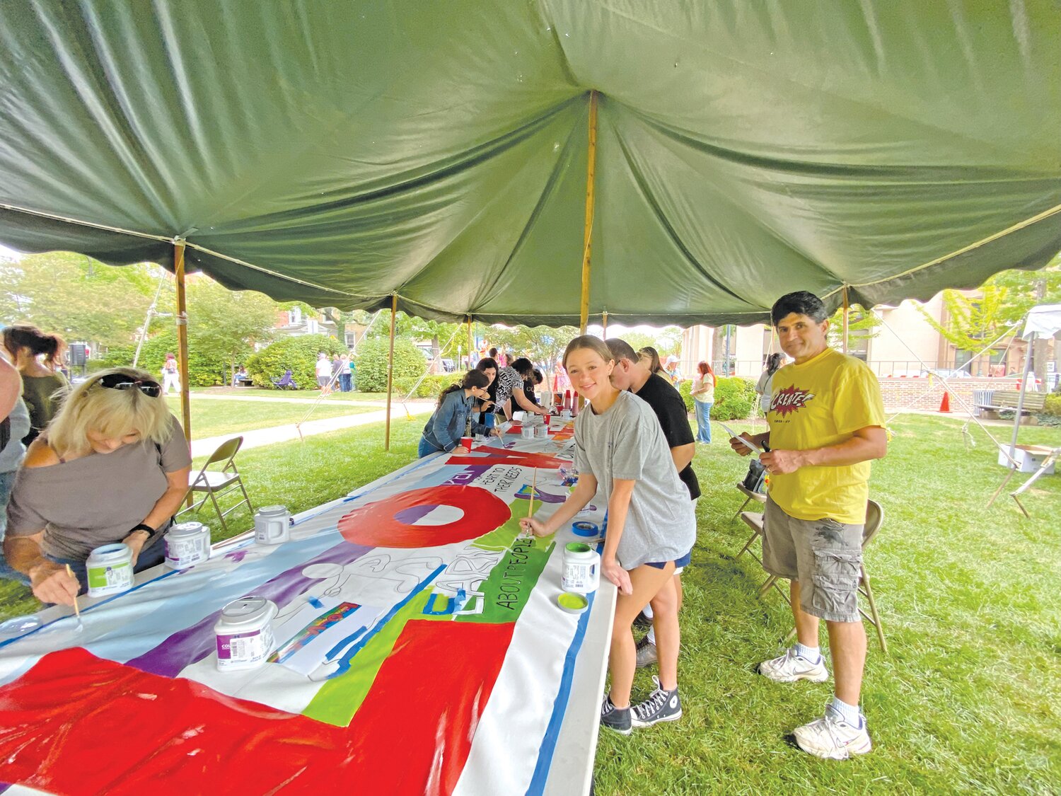 Community members work on a “L.O.V.E. is the Answer” mural that is slated to be hung on the first floor of the county administration building in Doylestown.