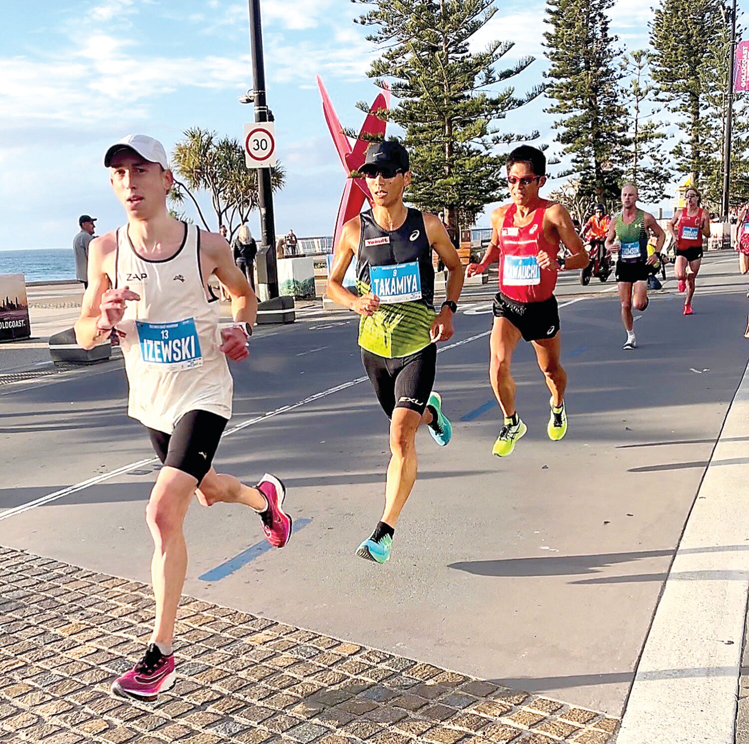 At this summer's Gold Coast Marathon in Australia, Central Bucks High School graduate Josh Izewski, left, finishes fifth overall in a personal record time of 2:11.26.