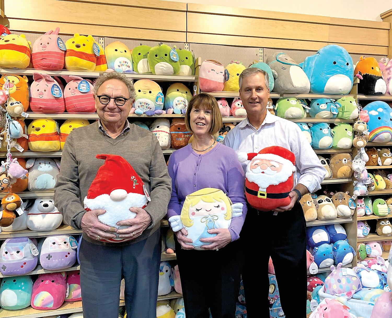 From left are Howard Henschel, Norman’s Hallmark president and chief executive officer; Noreen Batdorf, buyer; and Vince Navitsky, vice president of retail, all holding Squishmallows stuffed toys.