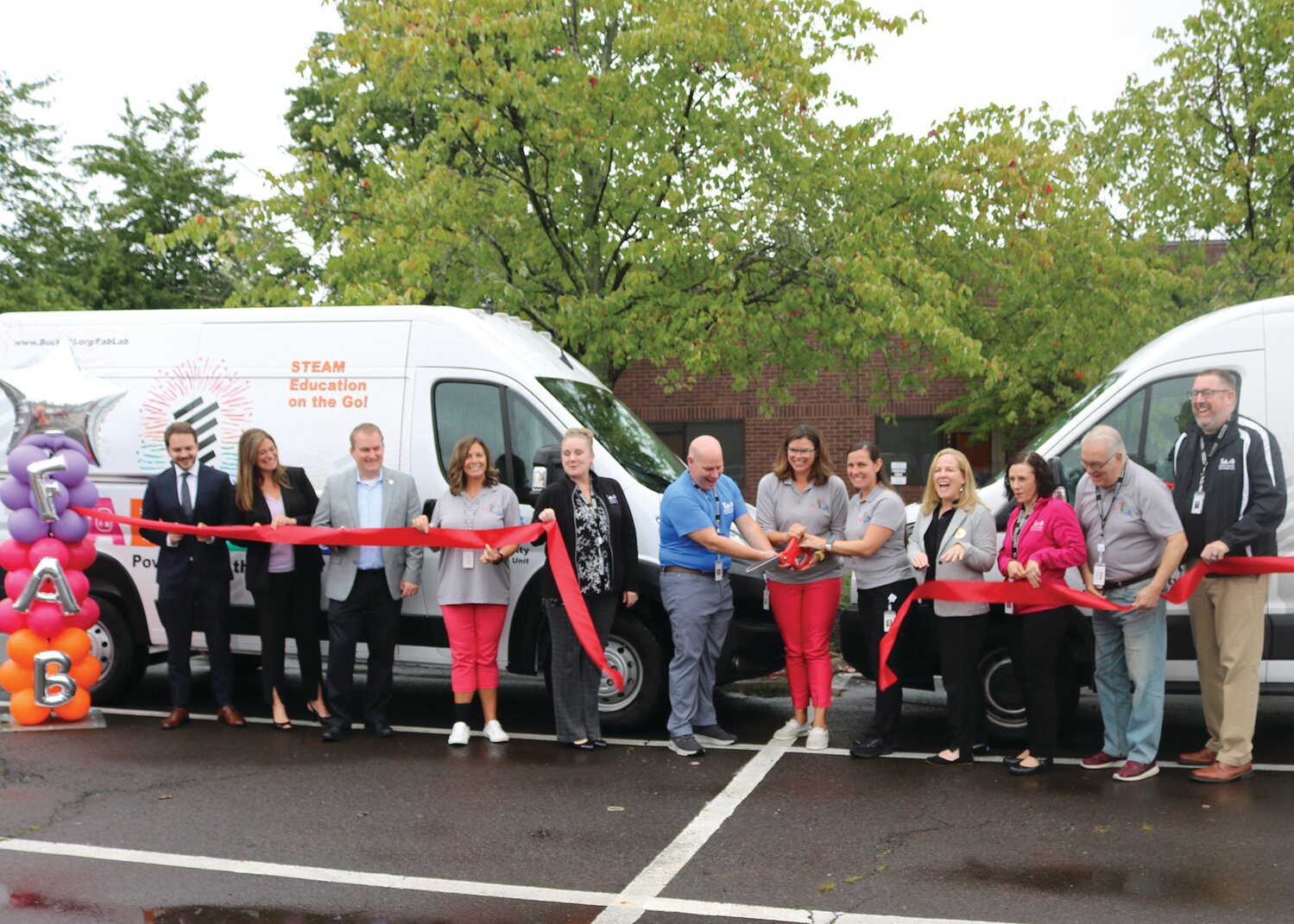 A ribbon cutting for the Bucks County Intermediate Unit’s second Mobile Fab Lab was held on Sept. 18.  From left are: Ethan Seletsky, U.S. Sen. Bob Casey’s office; state Rep. Kristin Marcell, state Rep. Brian Munroe, Bucks IU’s Nicole Borland, Dr. Mary Agnes DeCicco, Matt Hayden, Dr. Lindsey Sides and Megan Boletta; Shannon Sticker, state Sen. Steve Santarsiero’s office; and Bucks IU’s Dr. Rachel Holler, board President John D’Angelo and Dr. Mark Hoffman, Bucks IU executive director.
