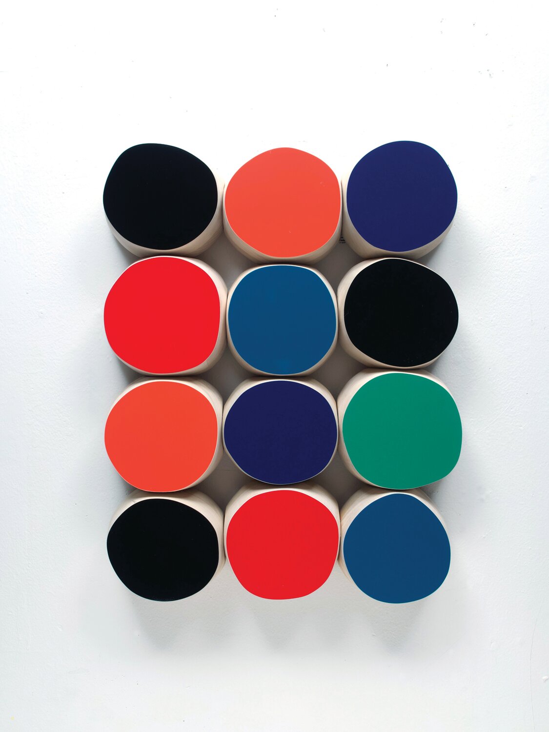 “Black, Orange, Blue, Red and Green” is automotive paint on wood by Andrew Zimmerman.