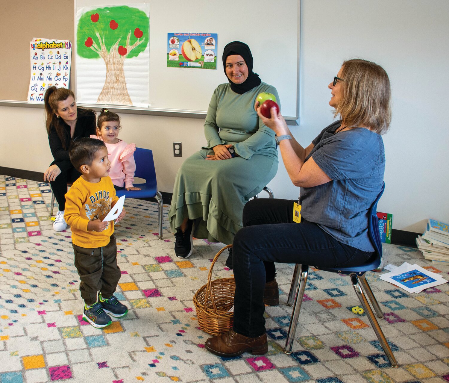 Tina Ruckh, a professional teacher employed by Vita, incorporates apples into her Family Literacy class in Levittown.