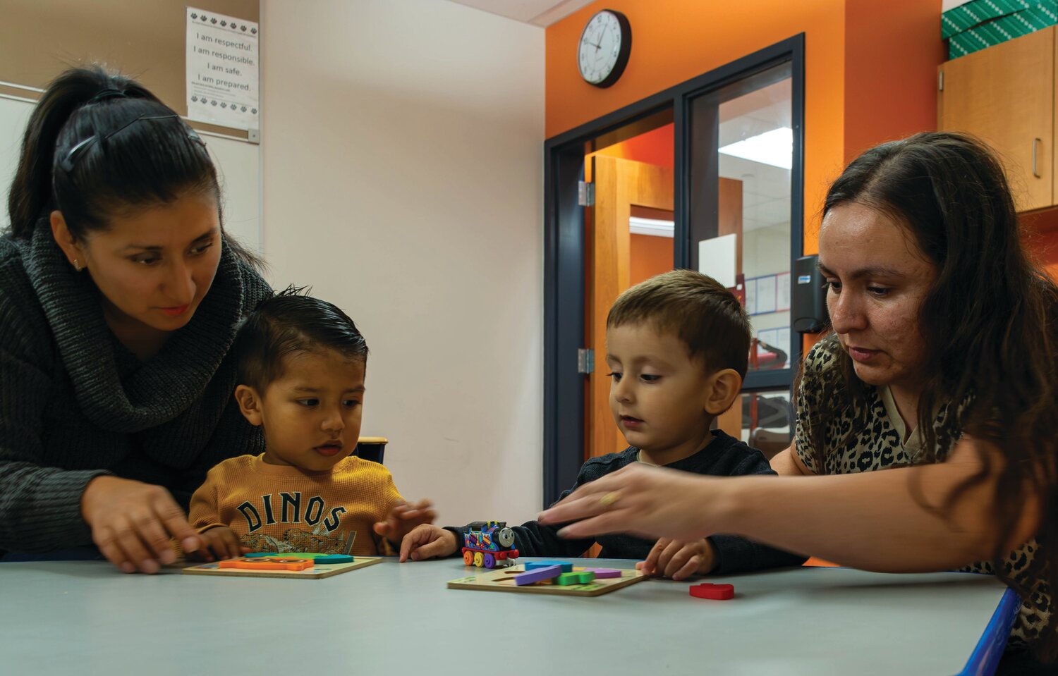 Carmen Minchala and her son Matteo Morocho sit with Salvador Murilo and his mother Josefa Luna as the boys work on some puzzles during a Family Literacy class in Vita’s Levittown location.