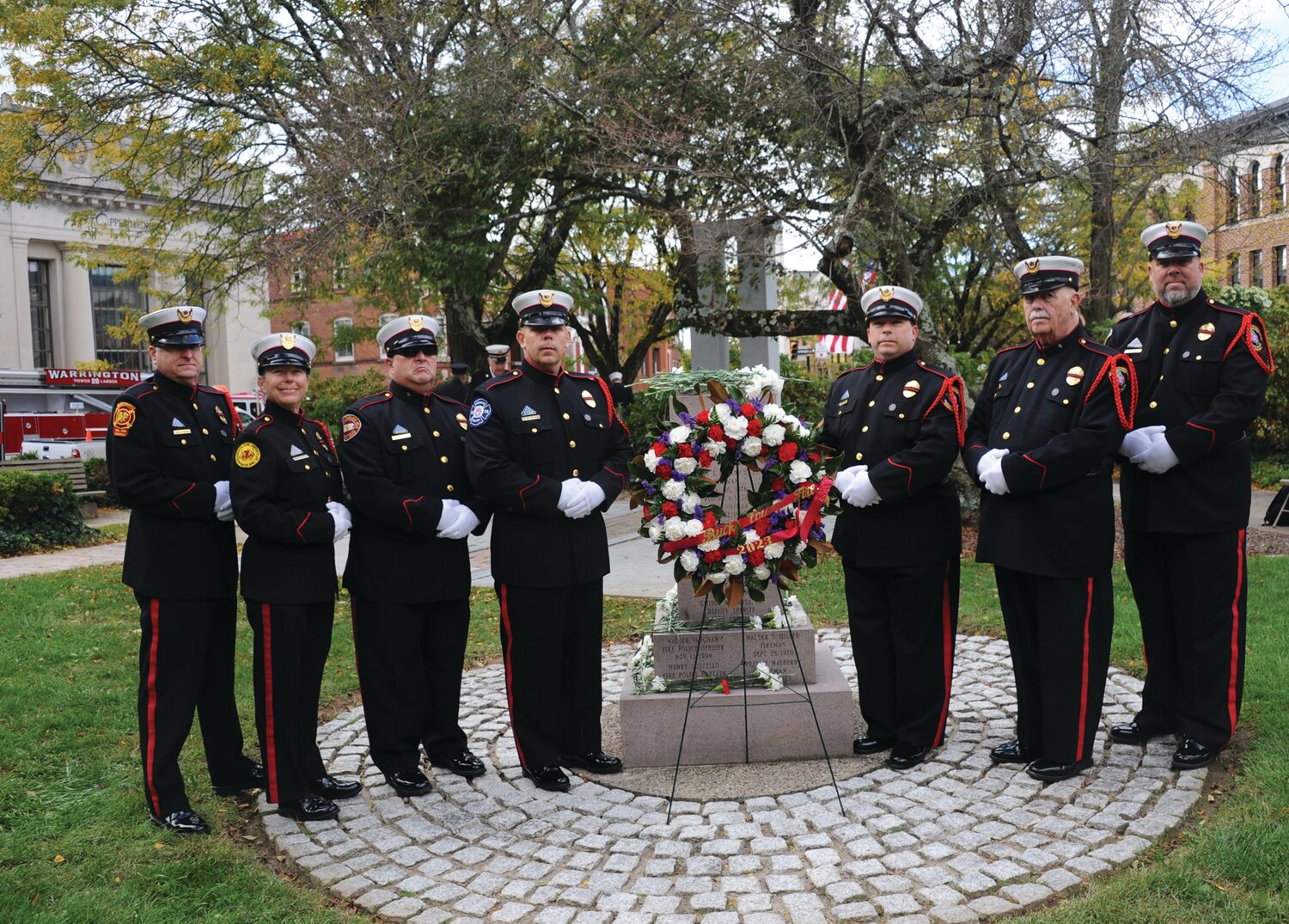 Members of the honor guard gather around a wreath placed in remembrance of Bucks County’s fallen firefighters.
