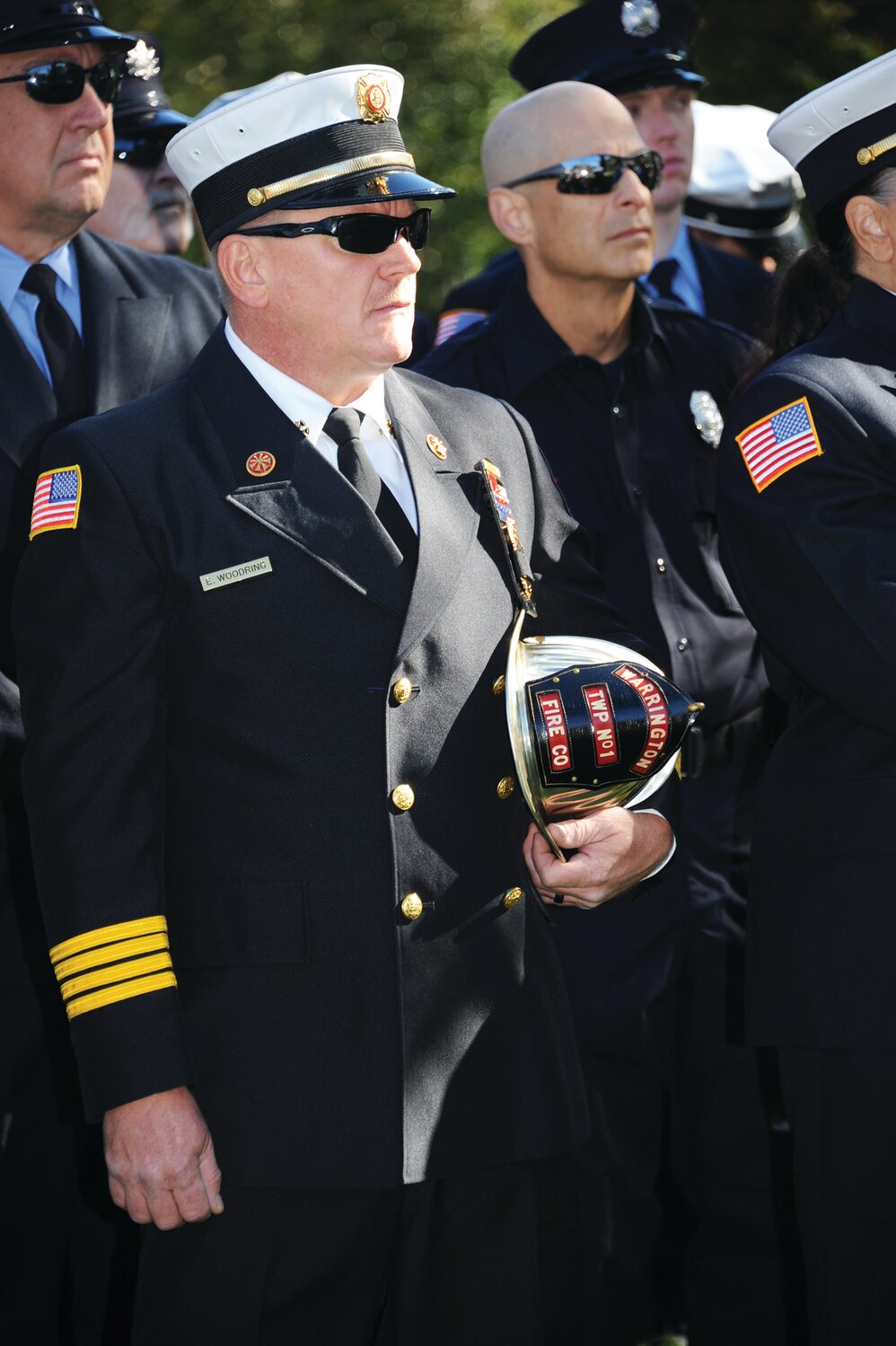 A firefighter holds a Warrington Township No. 1 Fire Company helmet at the Oct. 8 ceremony honoring Bucks County’s fallen firefighters.