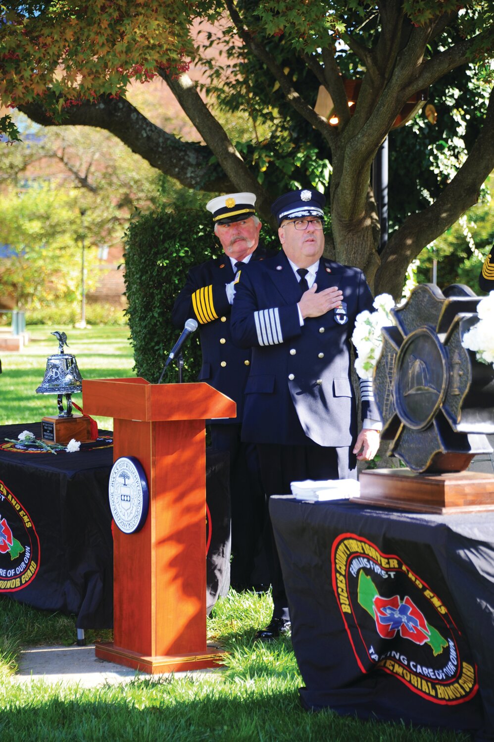 Paul Kreuter, co-chair, Bucks County Fallen Firefighters Memorial Committee, places his hand over his heart.