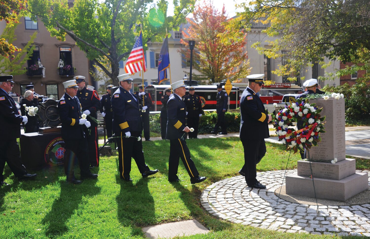 First responders place carnations in remembrance of Bucks County’s fallen firefighters.