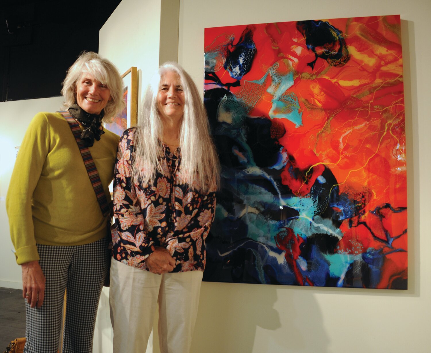 Cay Maria Adams and Janet Rockware with her painting “Intrigue.”