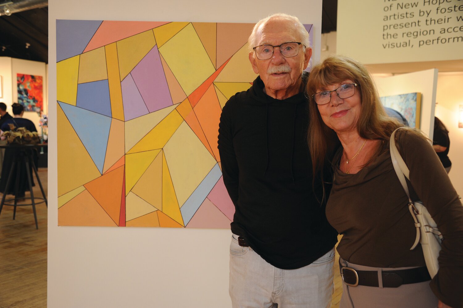 Jim Hamilton with his painting, “Clock Work Oranges #34,” and Laura Rizio.