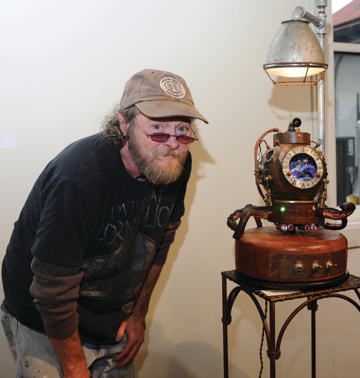 Jason Rogan with his sculpture, “Land Rover Octopus.”