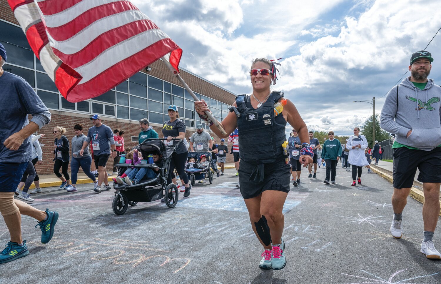 A runner waves the American flag while taking part in the Heroes Run.