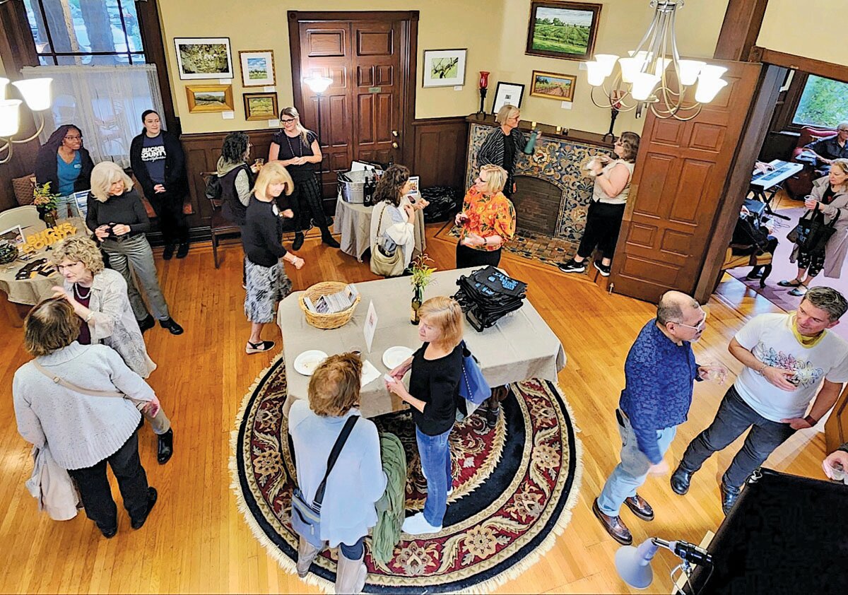 A crowd of 125 people attends the closing reception, at Freeman Hall, of the Wine & Art Trail Exhibition, a joint project of Visit Bucks County and the Arts and Cultural Council of Bucks County.