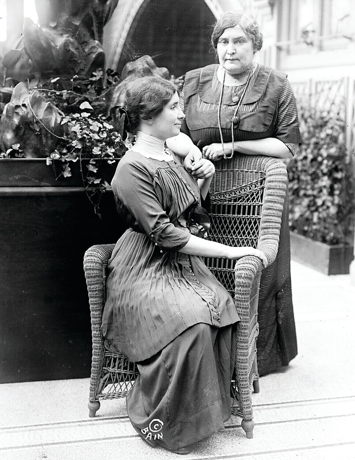 Helen Keller, seated, with Anne Sullivan.