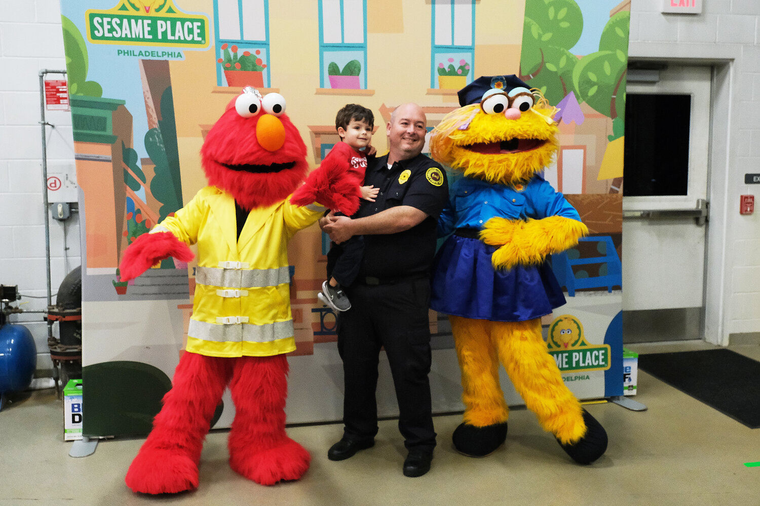 Pat McWilliams, with his 3-year-old son Declan, poses with Elm and Zoe, from Sesame Place.