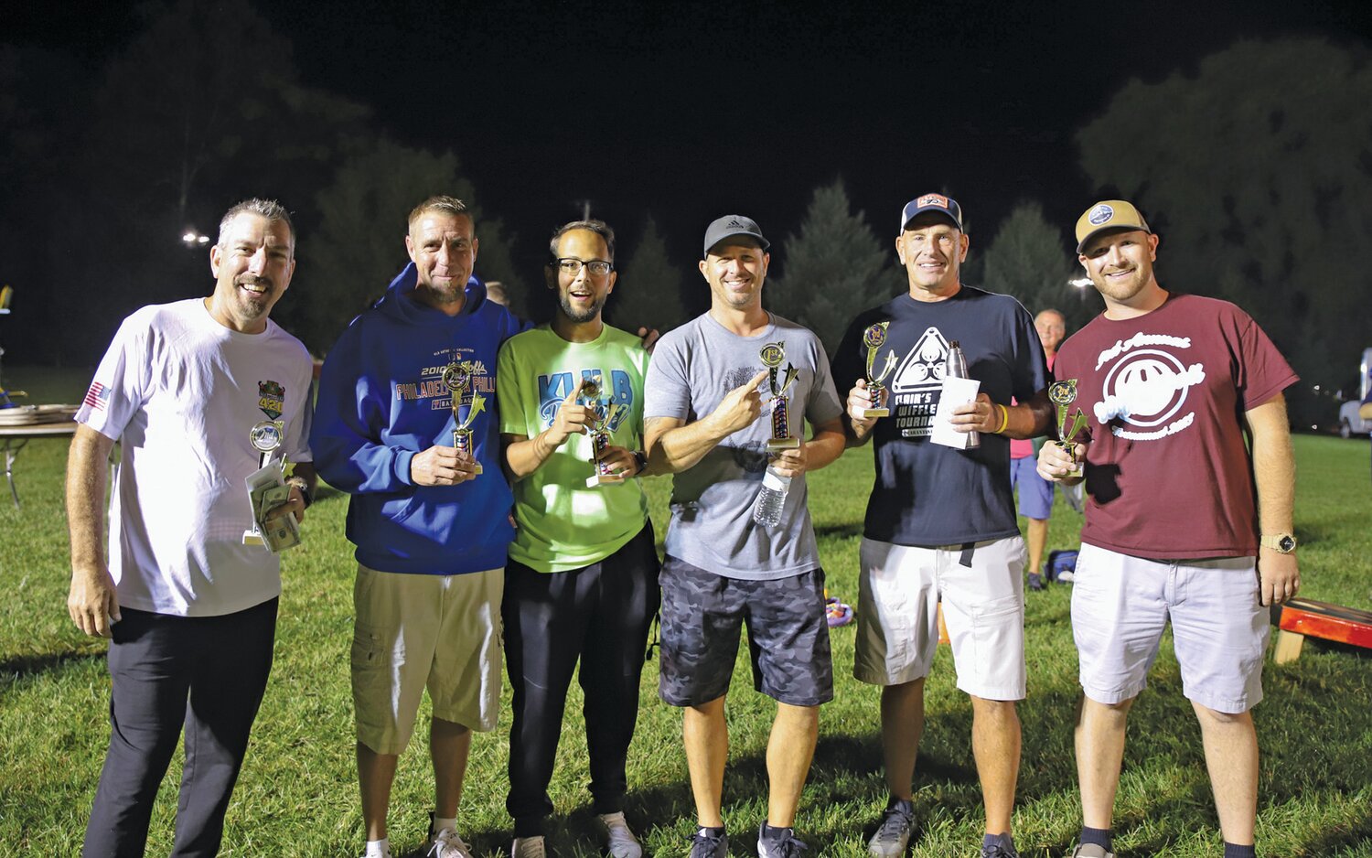 The top three teams of the cornhole tournament won cash prizes ranging from $1,200 to $300 as well as tournament trophies. From left are the second-place Bag Boys team, first-place winners The Outsiders and third-place team Dietz.