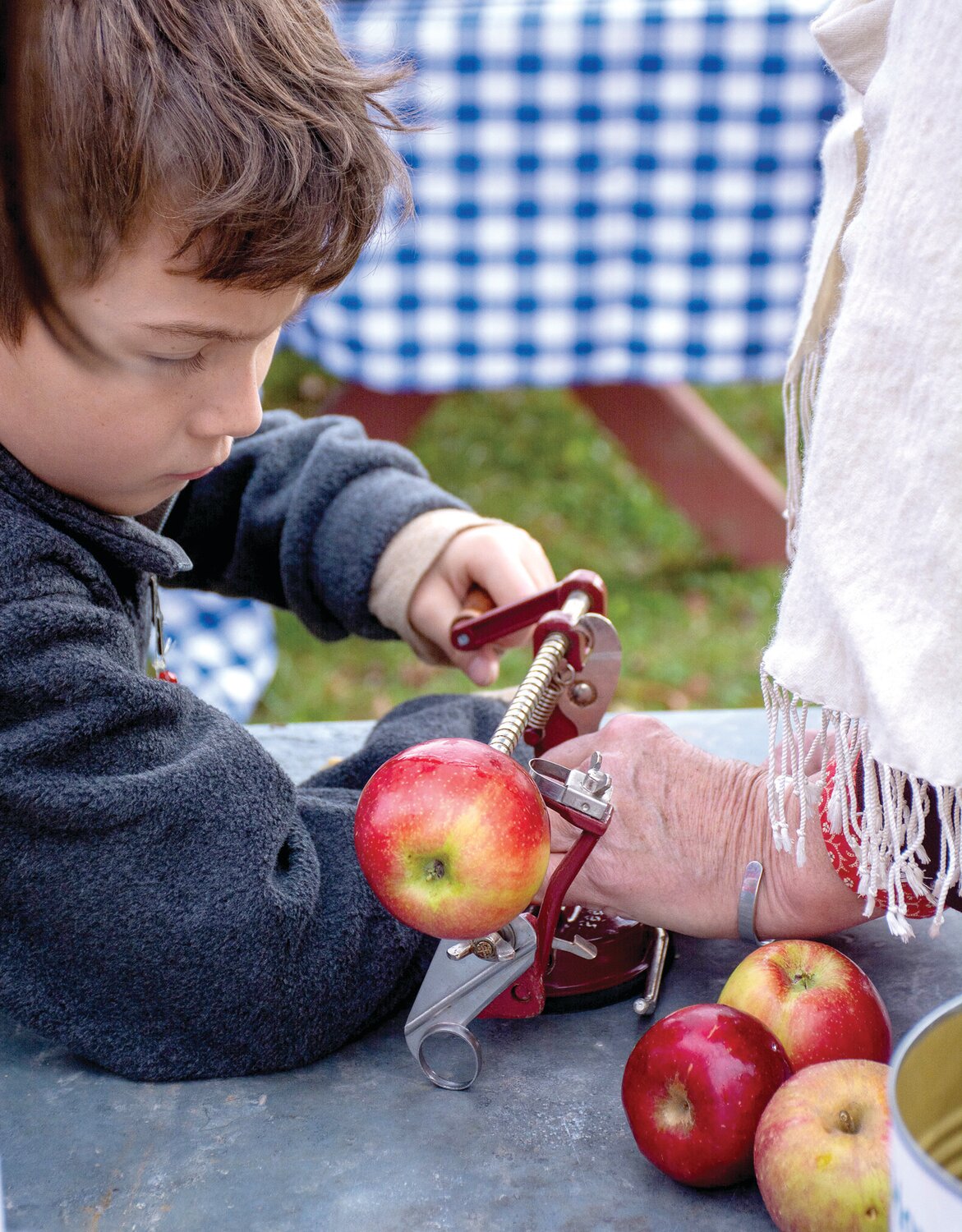 A child gets ready to peel an apple.
