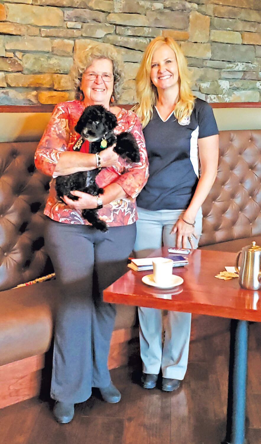 Woman’s Club of Quakertown Program Committee member Stephanie Simak, holding Fitz, and Heather Lloyd of Tails of Valor.