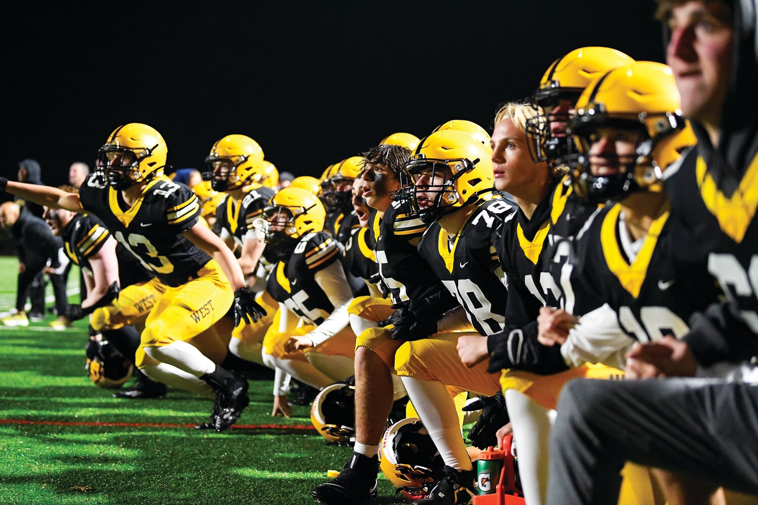Central Bucks West players line up arm-in-arm to watch the extra-point kick in overtime.