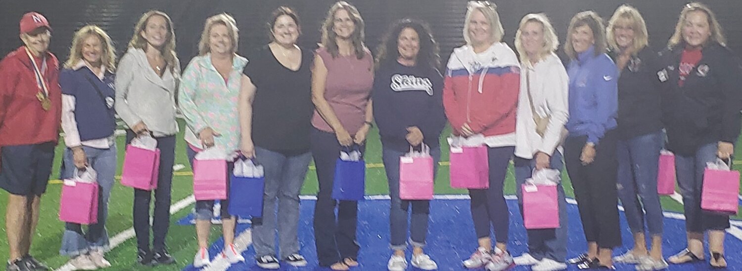 Members of Neshaminy’s 1983 state champion field hockey team gather at a celebration on Oct. 5. From left are: coach Sheila Murphy, Carol Vile (wearing her road jersey from 1983), Chris Stanford, Kelly Simonds, Marie Sheenan, Melinda Sears, Linda Pellegrino, Kelly Megahan, Kelly Kopack, Lisa Dengler, Cindy Daeche and Carol Cunningham.