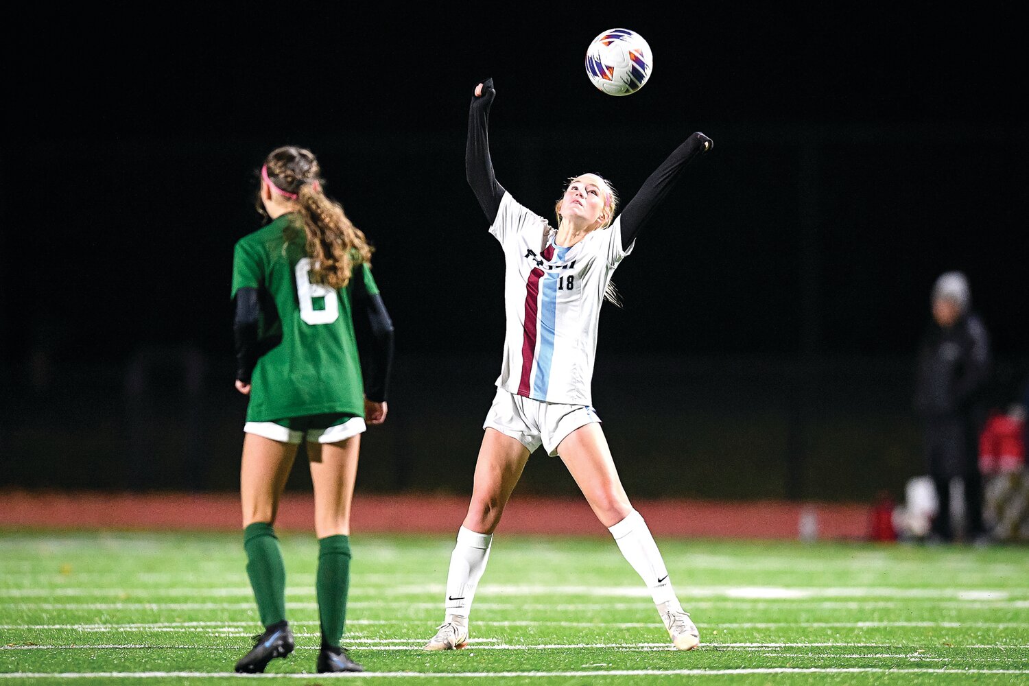 Faith Christian’s Sarah Frei lines up a header at midfield during the first half.