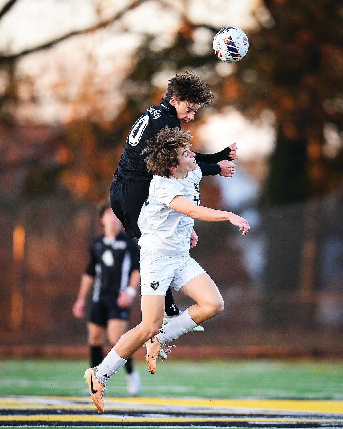 Faith Christian’s Logan Moore just beats Delco Christian’s Ben Norbury to a midfield header.