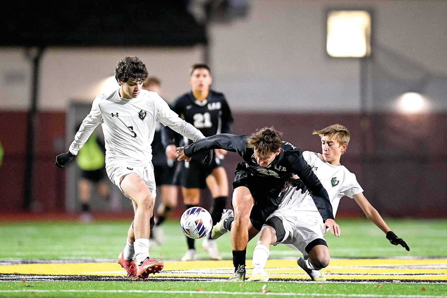 Faith’s Guilherme Machado is sent to the ground while trying to split the double team of Ryan Carroll and Brecon Williams.