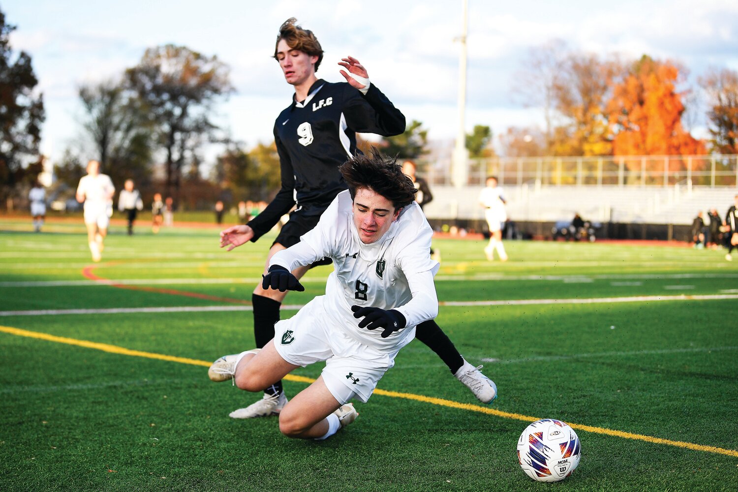 Faith Christian’s Colin Moyer sends Delco Christian’s Matteo DeBellis sprawling after colliding while chasing a loose ball.