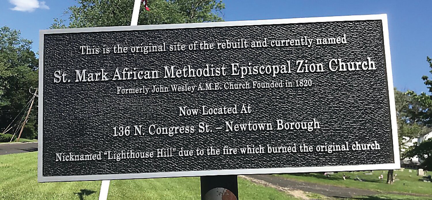 The Lighthouse Hill Cemetery Sign, 2021, tells part of the story of the A.M.E. church in Newtown. The site was nicknamed “Lighthouse Hill” because an 1840 fire that burned the church down could be seen for miles.