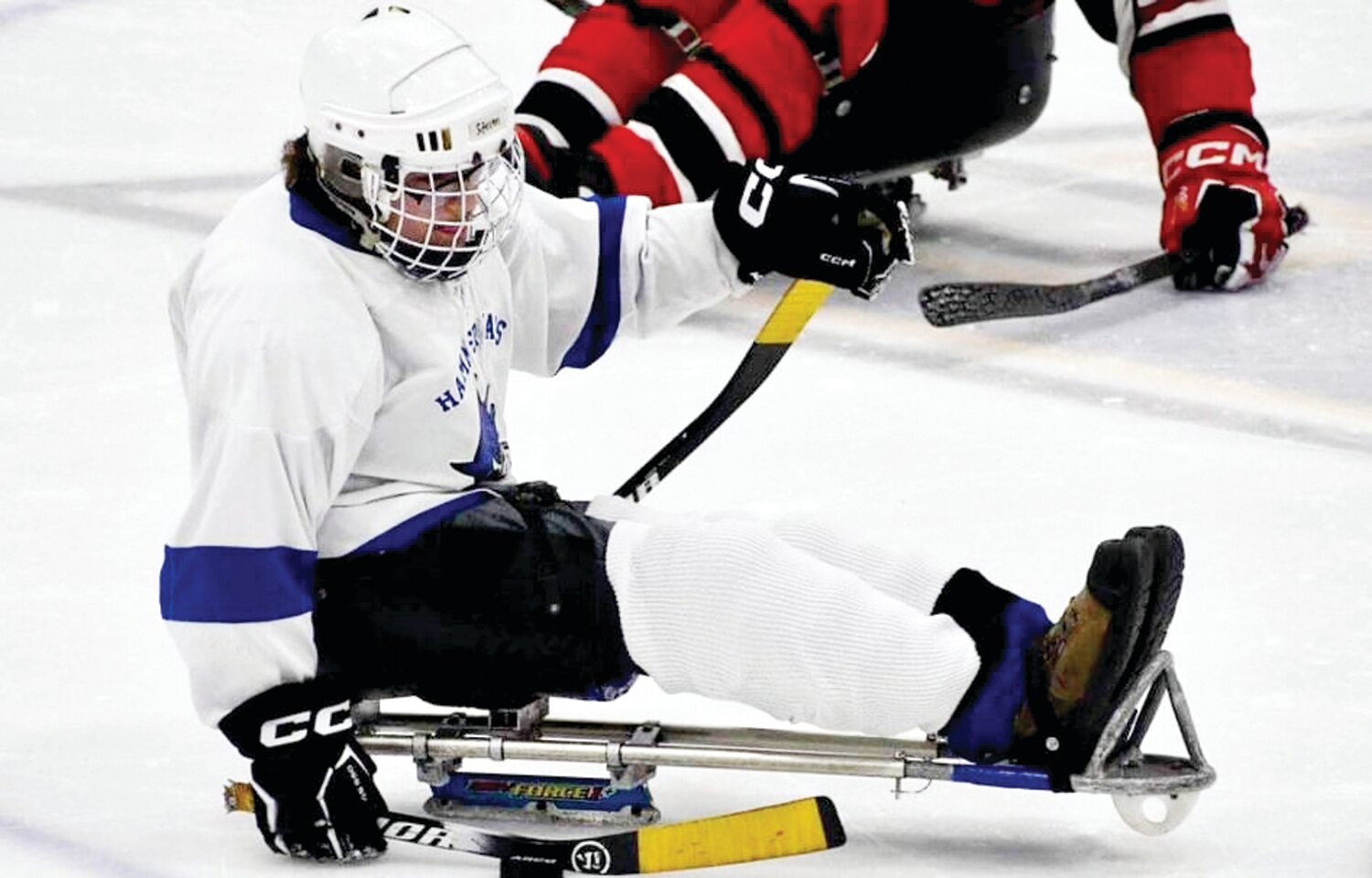 Stephen Bleacher from Voorhees, N.J. catches the puck with his right-hand stick during a sled hockey game.