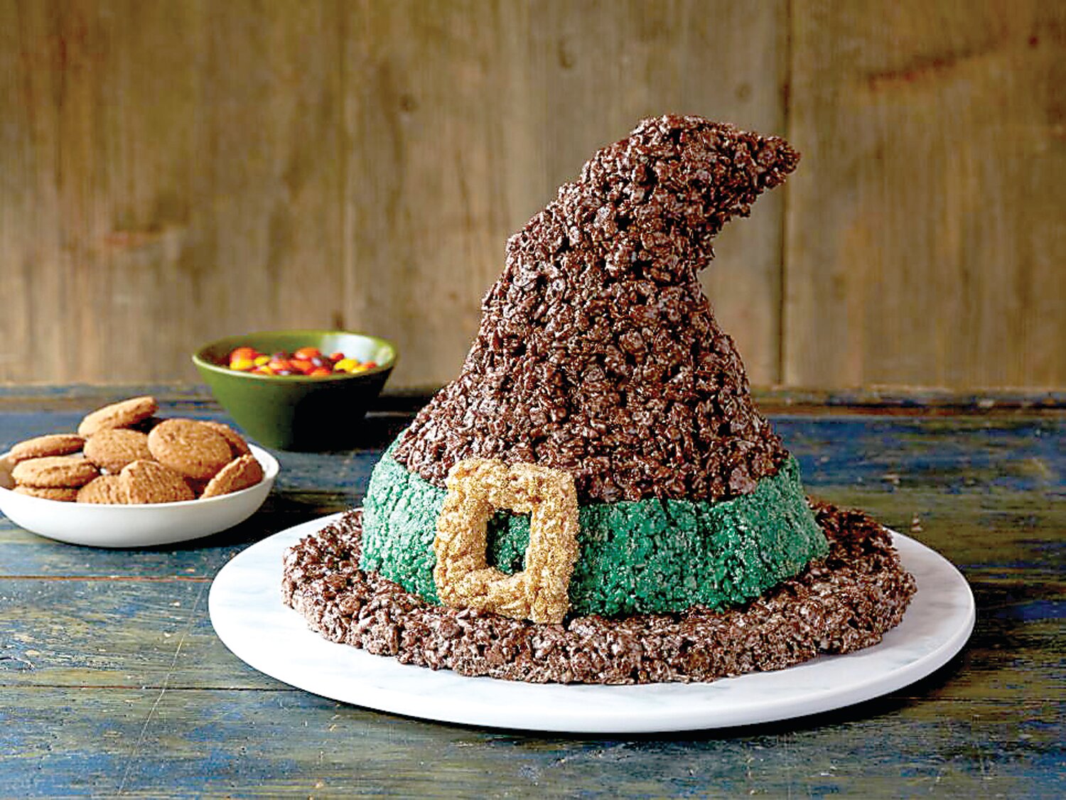 Chocolate crisped rice cereal becomes a witch’s hat with a little ingenuity mixed with melted marshmallow and food coloring.