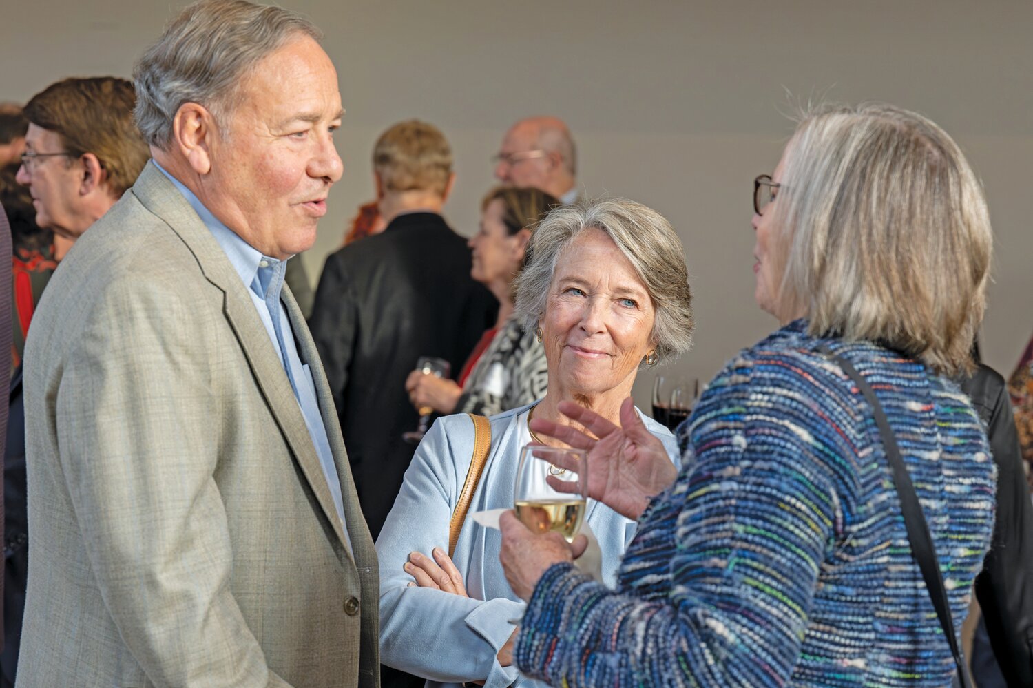 George and Anne Yarnell chat with an attendee of the “Happy to be Here” celebration.