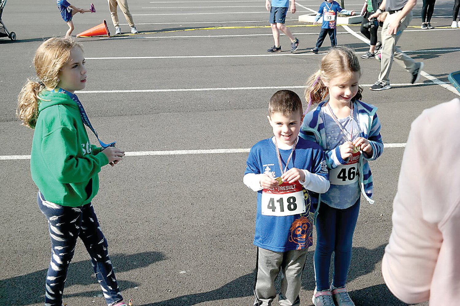 Youngsters collect their medals after competing in the Kids' Sprint at the 2023 Sesame Place Classic in Langhorne.