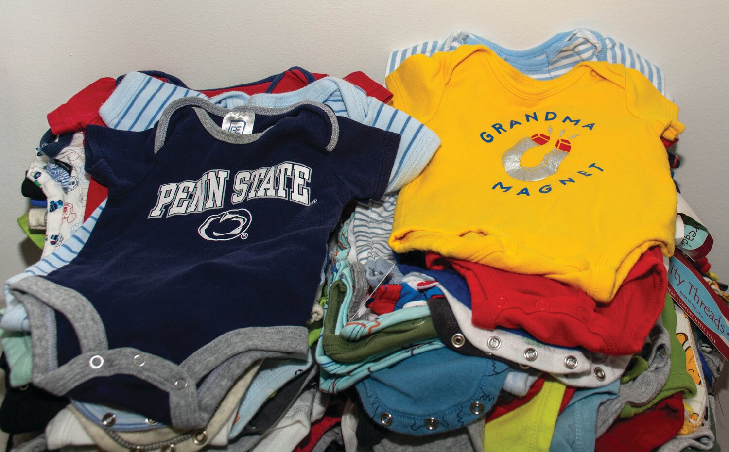 Onesies are washed, folded and sorted prior to being placed in bundles.