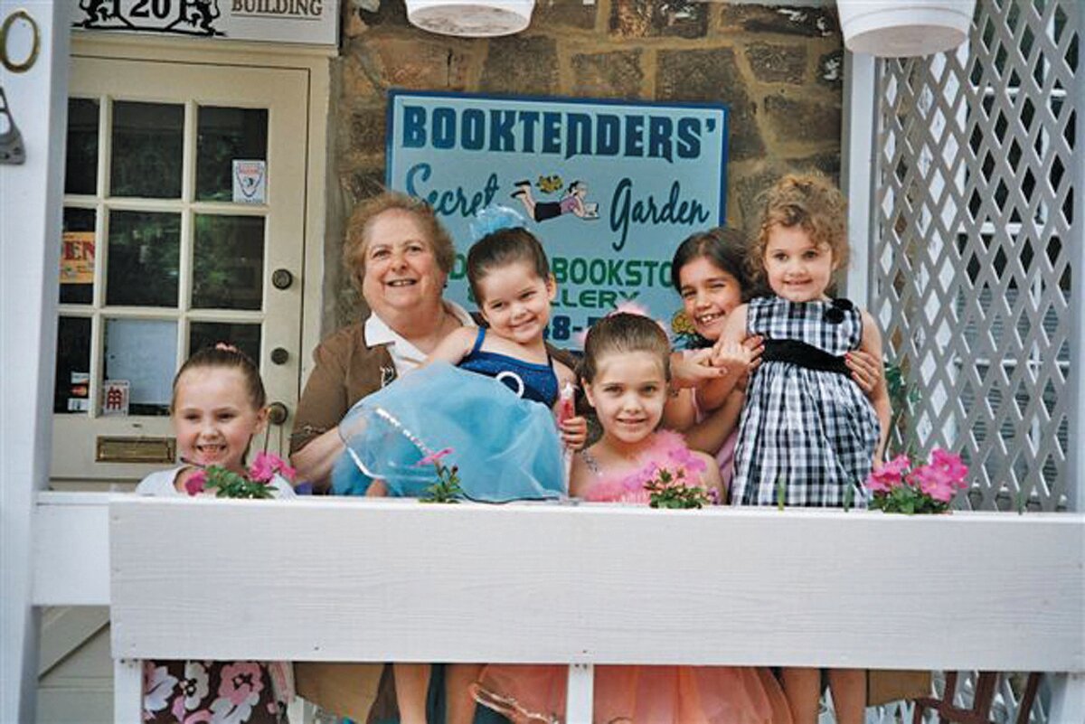 Ellen Mager, second from left, poses with some of her regular customers on the porch of her Booktenders' Secret Garden store in Doylestown store several years ago.