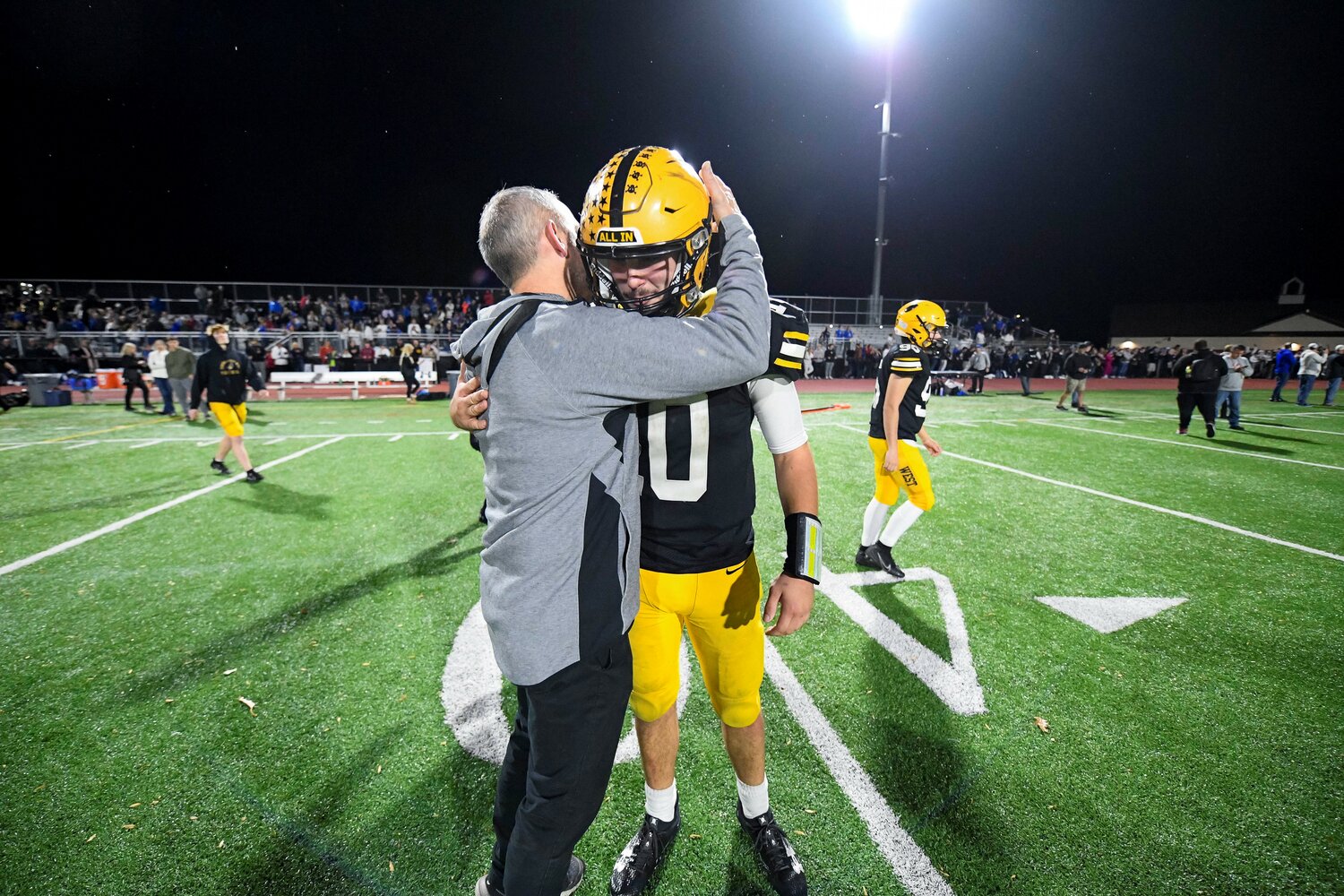 A dejected Cooper Taylor of Central Bucks West gets a hug from Central Bucks South coach Tom Hetrick.