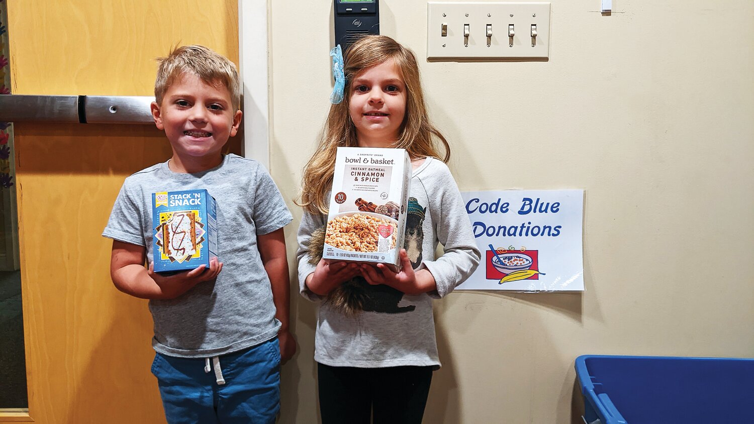 Transitional kindergarten class students at Woodside Christian Preschool hold donations for Code Blue.