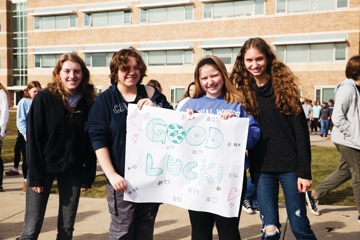 Pennridge High School seniors Maggie Lutz, Silas Nathan, Laney Minko and Emma Allen cheer on the Rams at the sendoff for the team ahead of the PIAA championship game Friday.