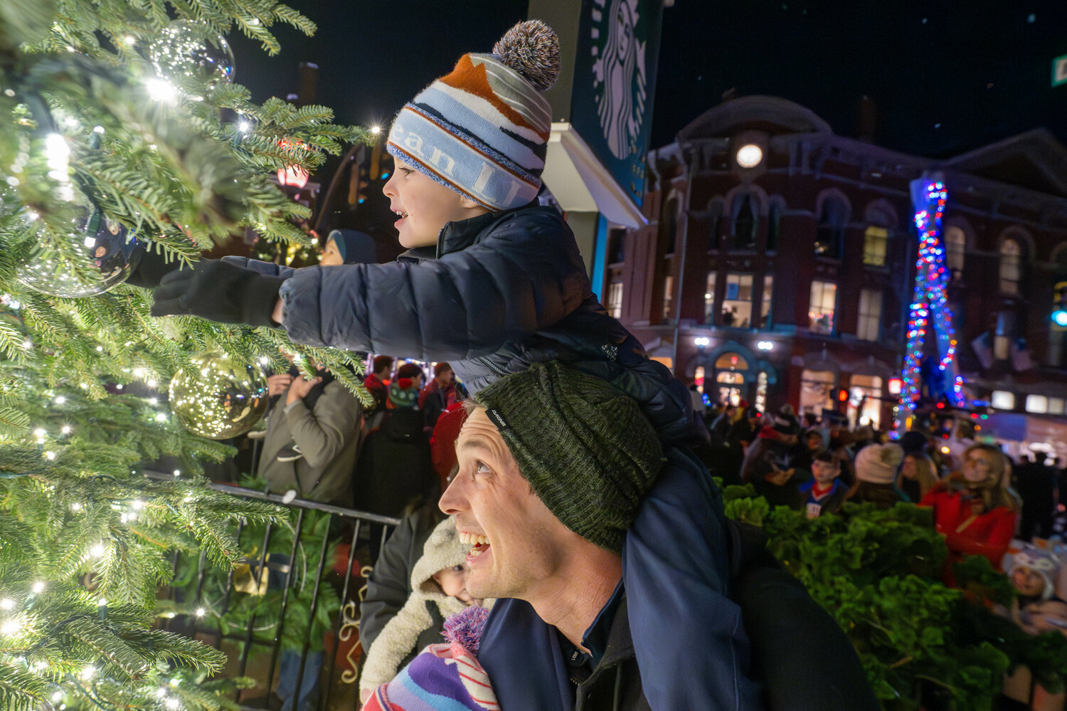 Dan Piasecki and son Liam Piasecki enjoy viewing the lights on the newly lit Christmas Tree at the Doylestown Borough Christmas Tree Lighting event Friday night.