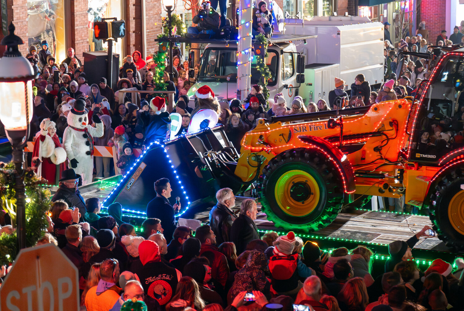 A decorated SJR Fire LLC wheel loader takes part in Friday night’s holiday parade in Doylestown Borough.