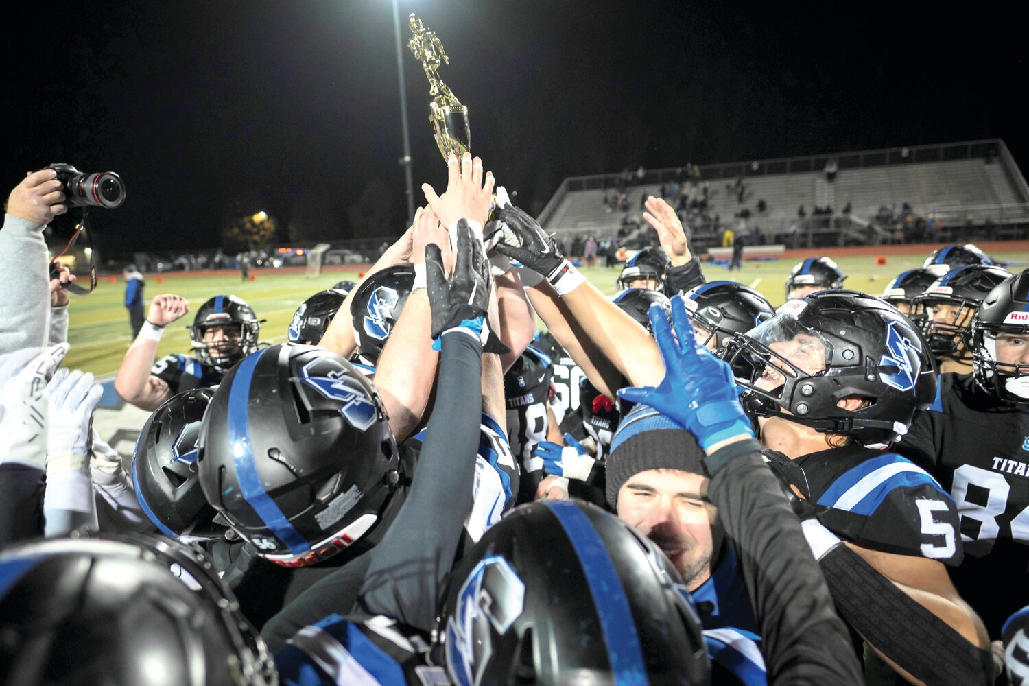 Members of the Central Bucks South football team hoist the District One Class 6A trophy after defeating Downingtown West 27-7 Friday night in Warrington.